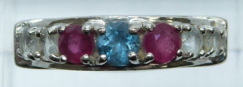 A 9ct white gold ring set with a topaz, rubies and paste, 4g, size O/P