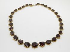 Georgian/ Victorian yellow metal necklace set with graduated foiled garnets