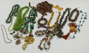 A collection of beaded necklaces including carved wood, ceramic, amber, agate etc