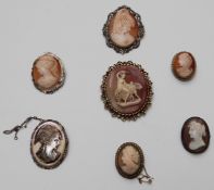 A collection of silver and cameo brooches