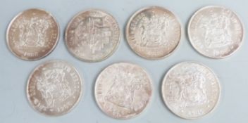 Seven 1980s South African Mint silver 1 Rand commemorative coins