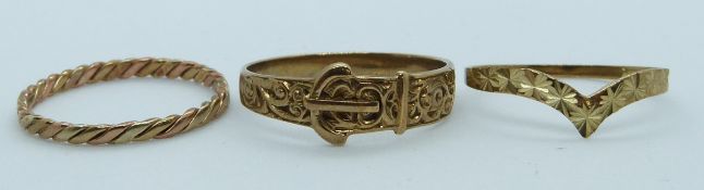 Three 9ct gold rings including one in the form of a buckle and one of ridged design, 3.6g