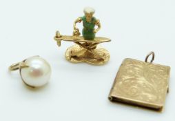 Three 9ct gold charms, one in the form of a book, one set with a pearl and the other in the form