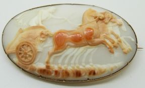 A large Victorian brooch set with a cameo depicting chariot and horses, marked W.L.A, 6.2 x 3.7cm