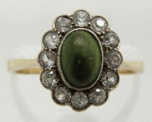 An 18ct gold ring set with turquoise cabochon surrounded by spinel, 2.1g, size L