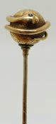 Victorian stick pin in the form of a snake wrapped around an engraved sphere