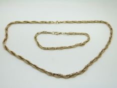 A 9ct gold necklace made up of elongated links (28.5g) and matching bracelet (8.3g), in original