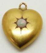 A 15ct gold heart shaped pendant set with an opal cabochon, maker H & M, 1.5 x 1.8cm
