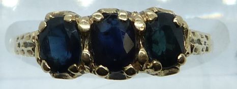 A 9ct gold ring set with three sapphires, 2.0g, size O