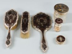 Circa George V hallmarked silver and piqué work tortoiseshell dressing table set comprising hand
