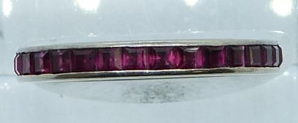 An 18ct white gold eternity ring set with square cut rubies, 1.5g, size M