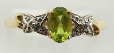 A 9ct gold ring set with an oval cut peridot and diamonds, 1.6g, size P