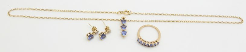 A suite of 9ct gold jewellery set with tanzanite, comprising earrings, pendant and ring