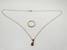 A 9ct gold necklace set with garnets and a 9ct wedding band, 2.4g