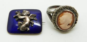 A silver brooch set with enamel depicting a cherub and a cameo ring