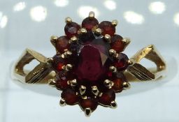 A 9ct gold ring set with a cluster of garnets, 2.3g, size P