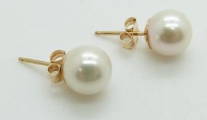 A pair of 9ct gold earrings set with a pearl to each