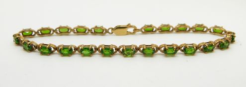 A 9ct gold tennis bracelet set with oval cut Russian diopside, 7.7g