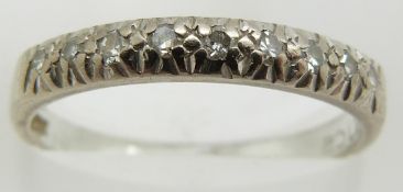An 18ct white gold half eternity ring set with diamonds, 2.7g, size M/N