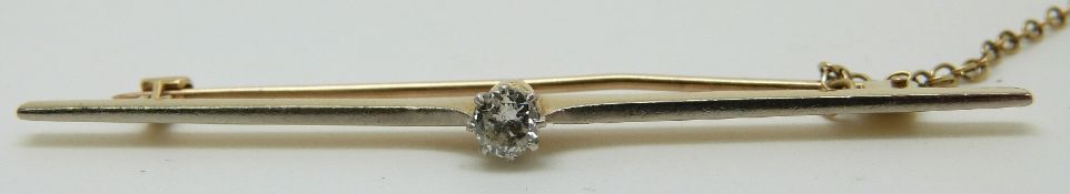 A yellow metal brooch with white metal finish set with a diamond of approximately 0.2ct, in