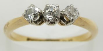 An 18ct gold ring set with three diamonds, 2.7g, size M
