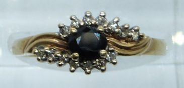 A 9ct gold ring set with a sapphire and diamonds, 2.2g, size N