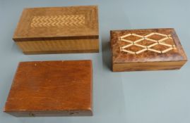 Two parquetry inlaid boxes, width of larger 25cm, together with a cased set of brass weights