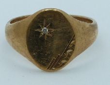 A 9ct gold signet ring set with a diamond, 5.1g, size S