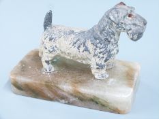 A cast metal figure of a Sealyham terrier on plinth, L12cm
