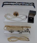A collection of costume jewellery including silver gilt ring, silver necklace, Sphinx peacock
