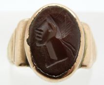 A yellow metal ring marked solid gold set with an agate intaglio, 4.6g, size K