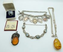 A silver fob chain and six hallmarked silver fobs, pressed amber pendants, silver bracelet etc