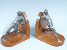 Pair of book ends formed as cast metal figures leaning backwards, H20cm