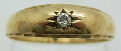 A 9ct gold ring set with a diamond in a star setting, 3.7g, size Y