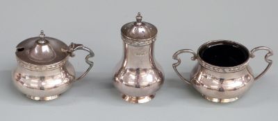 Walker and Hall three piece hallmarked silver cruet set with blue glass liners, Sheffield 1913,
