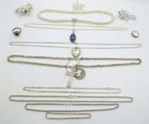 A collection of silver jewellery including rings, Art Deco silver heart locket, three silver