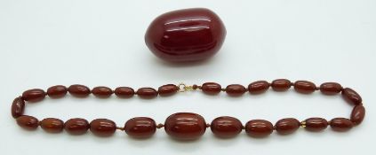 An amber necklace (22g) and large cherry amber bead (43g)