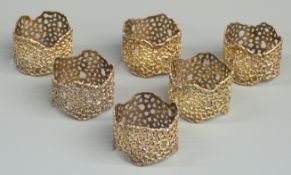 Set of six Stuart Devlin hallmarked silver gilt napkin rings with pierced textured decoration,