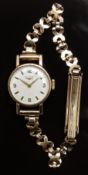 Longines 9ct gold ladies wristwatch with gold hands and hour markers, silver dial and signed