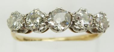 An 18ct gold ring set with five diamonds, the central diamond of approximately 0.33ct, 2.8g, size