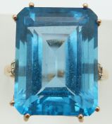 A 9ct gold ring set with an emerald cut treated blue topaz and diamonds, 8.4g, size Q