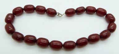 A cherry amber necklace made up of 20 oval beads, each approximately 17x12mm, 38g.