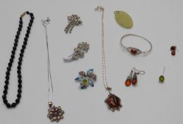 A collection of silver and pressed amber jewellery including earrings, bangle, pendant and other