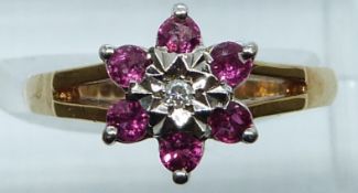 A 9ct gold ring set with a diamond and rubies, 3.2g, size N
