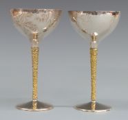 Pair of Stuart Devlin hallmarked silver chalices with gilt interior, hammered finish and textured