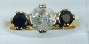 An 18ct gold ring set with a diamond of approximately 0.8ct and two sapphires, 3.9g, size M