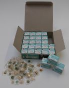 A large collection of wristwatch glasses, some Deluxe, in original box.