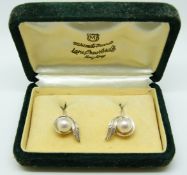 A pair of silver Mikimoto pearl earrings in original box