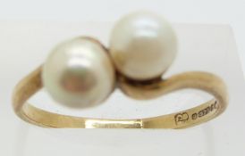 A 9ct gold ring set with two pearls, 2.7g, size S/T