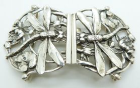 A hallmarked silver buckle depicting dragonfly, silver bracelet set with amethysts, silver brooch,